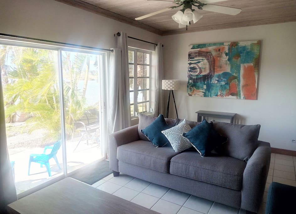 Front room / TV area with Patio & mangrove water view - Enjoy the sunset from the comfort of the Sofa