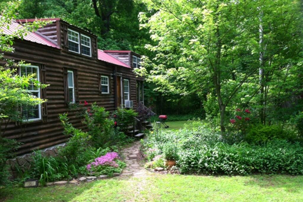 Summer flowers invite you down the path to the front door.