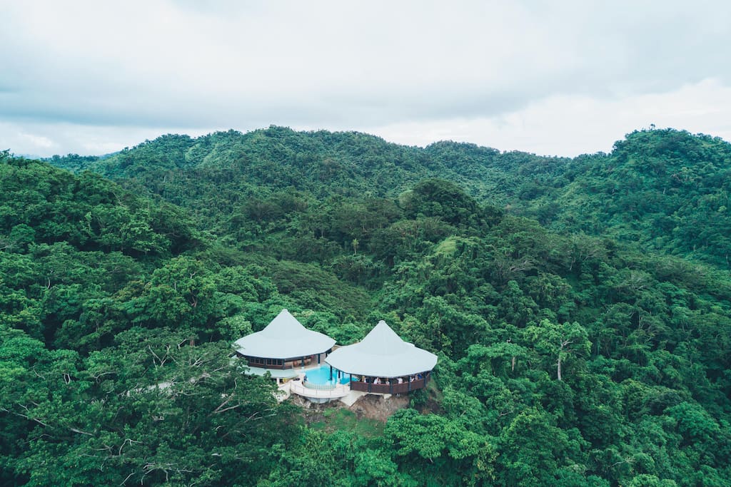 Aerial view of Mountain Top Villa, surrounded by rainforest and ocean views