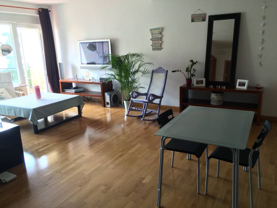 Large living room with dining table and air conditioning