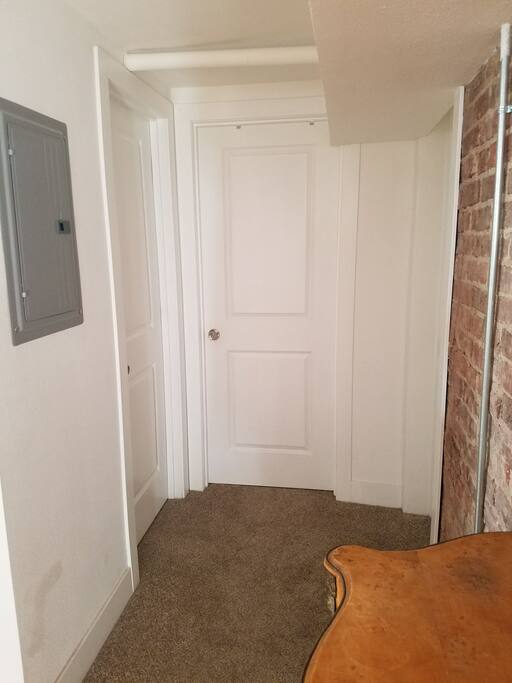 Entry to your room. Your private bathroom is through the door on the left.