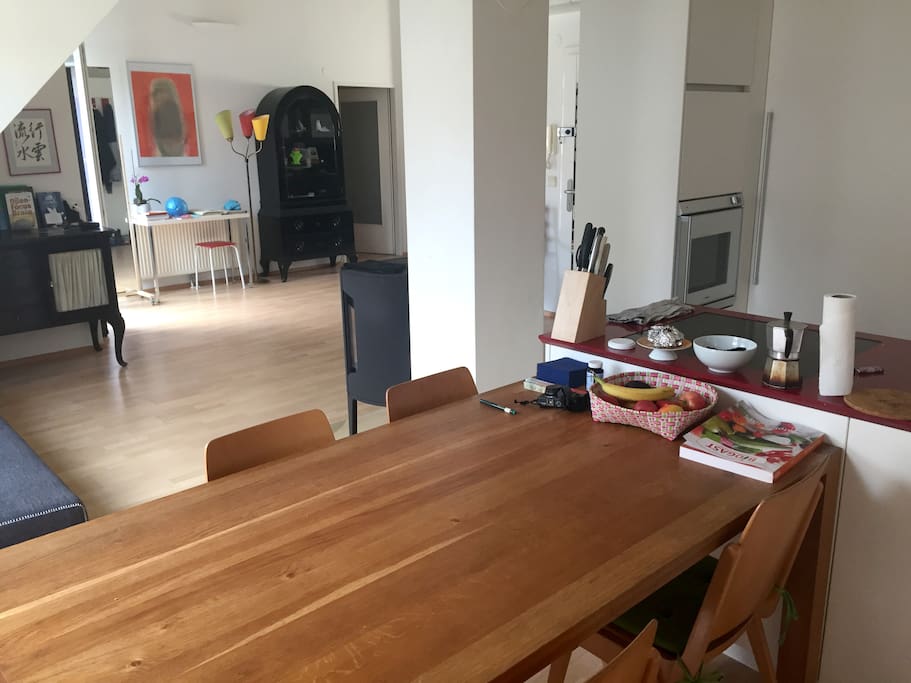 View from the dining table to the spacious living room with sofa.