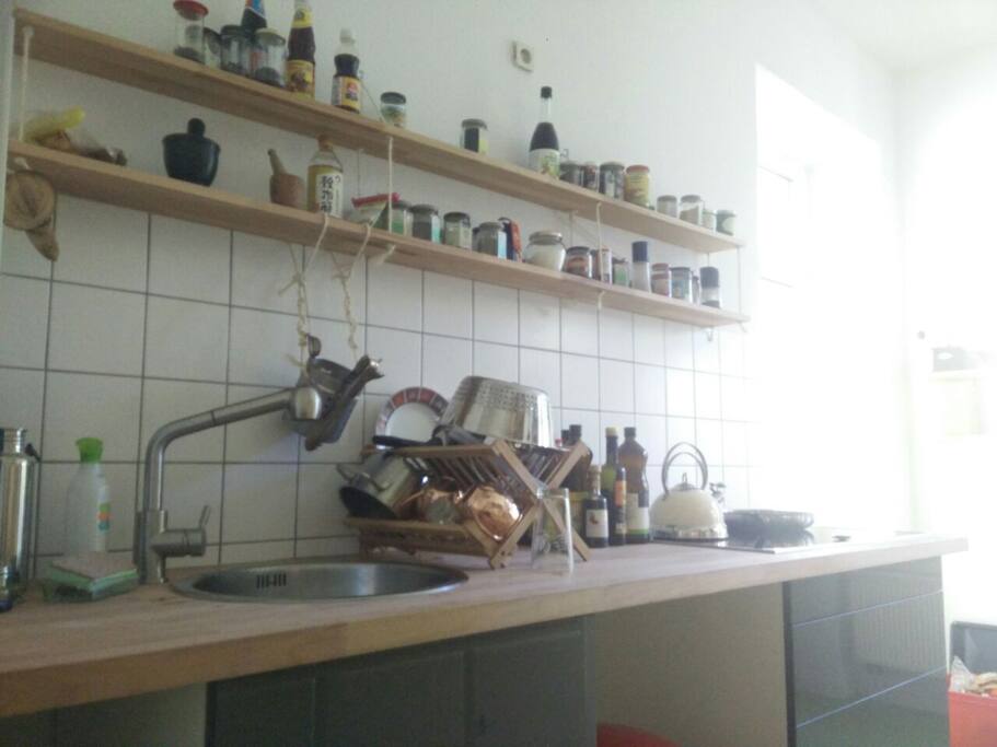 Kitchen with pots, pan and almost every spice you wish.