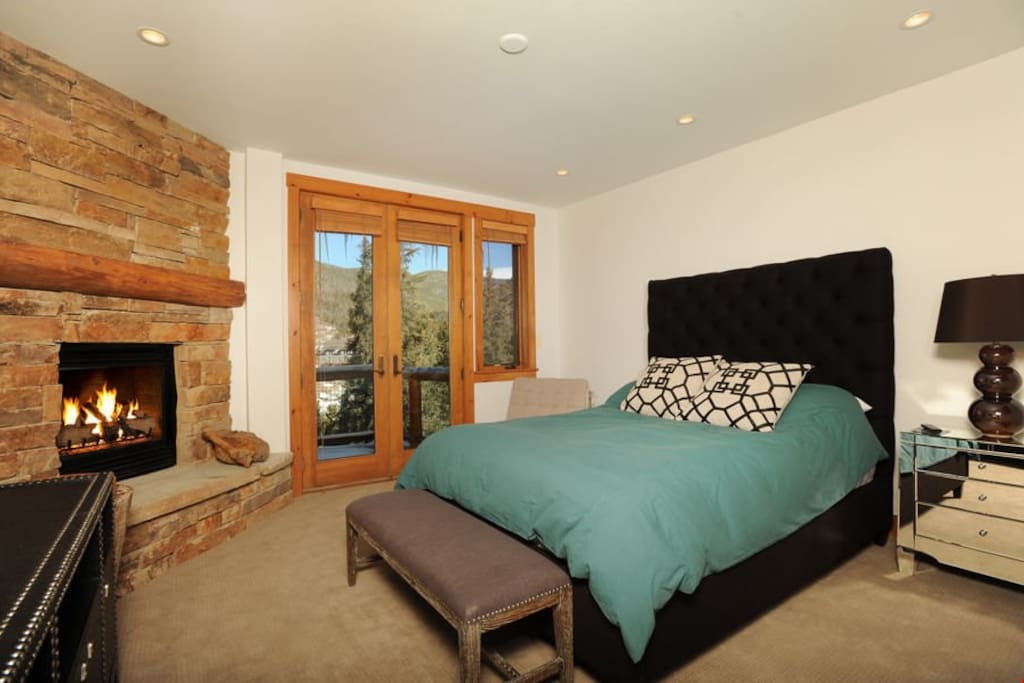 The master bedroom features a queen bed and access to the private balcony