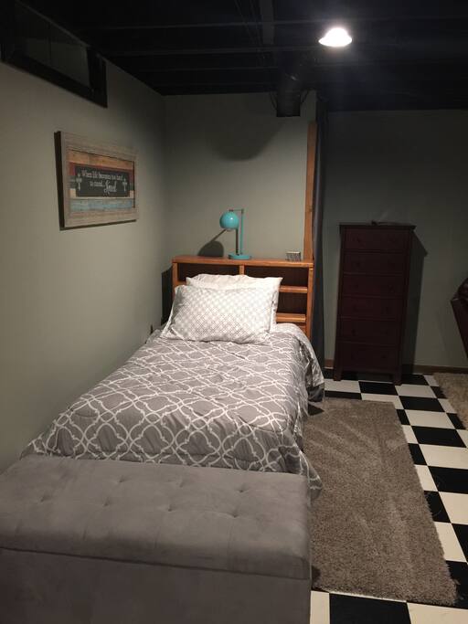 Twin size bed with lamp on headboard. Lamp has USB plug to charge your phone.