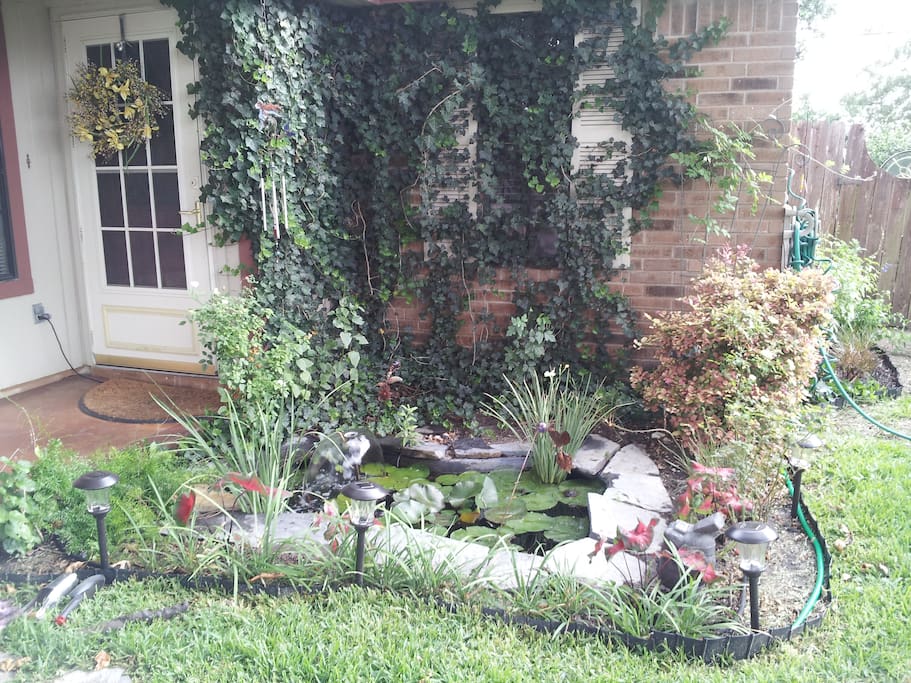 Inviting porch swing over a fountain Koi pond.