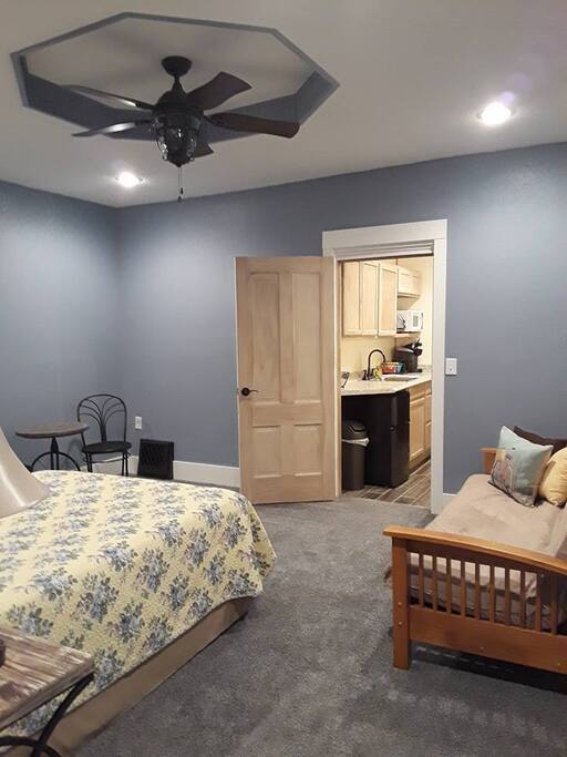 Queen bed and full-sized futon are featured in this room. It opens into the kitchenette which leads into the large living/dining area.