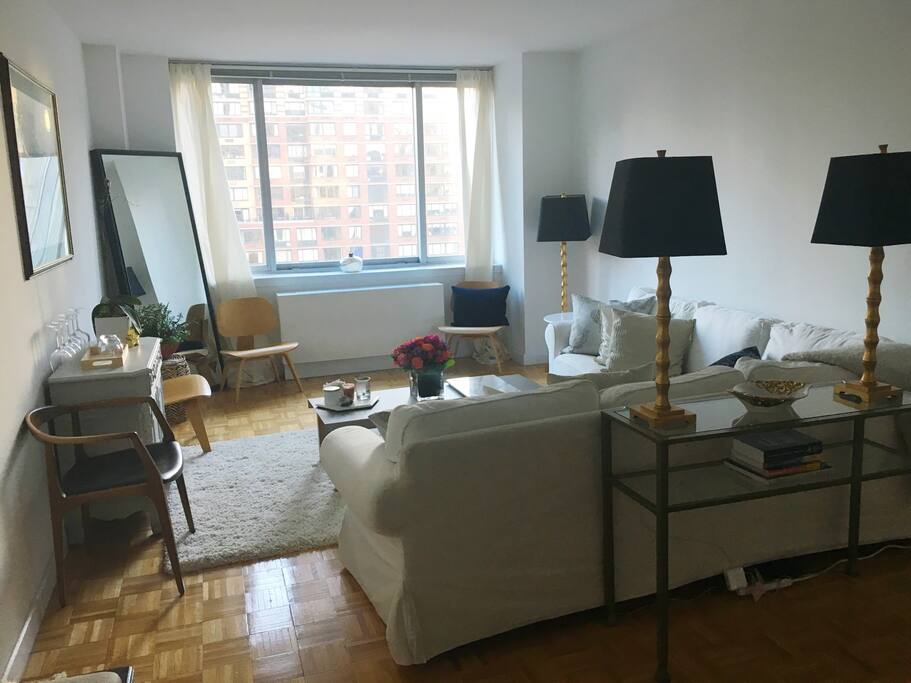 Living room. Tons of light during day, overlooks a park with greens and flowers.
