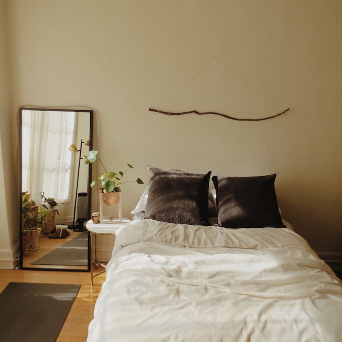 Full/queen bed that catches the warm morning light.