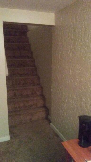 Stairs to the basement where your private oasis awaits you.