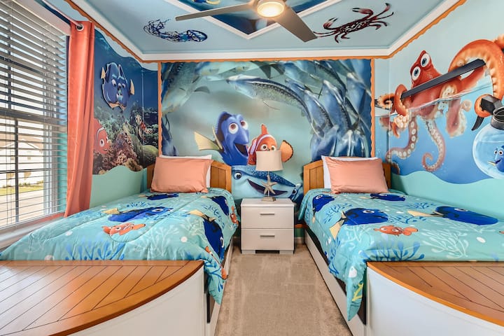 Finding Nemo-themed room featuring two well-decorated twin beds