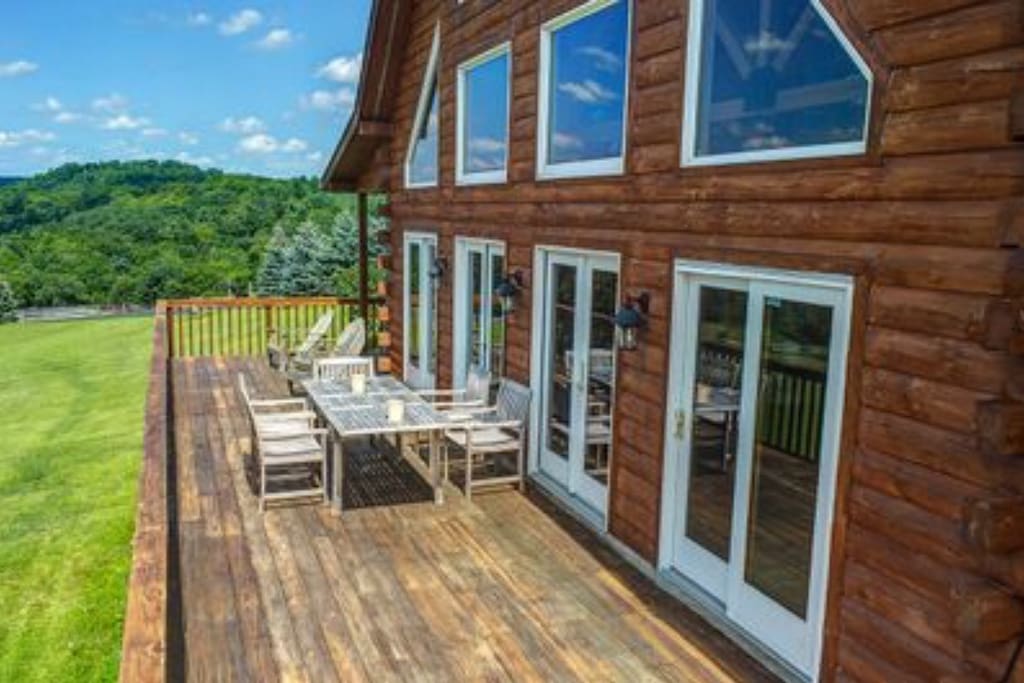 Huge deck has room for two or three of our outdoor tables and can seat 12-15 people. Views are spectacular.