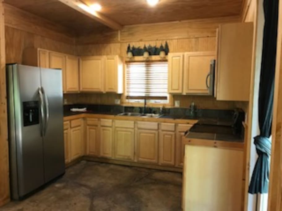 Full kitchen with fridge, stove, oven, and microwave.
