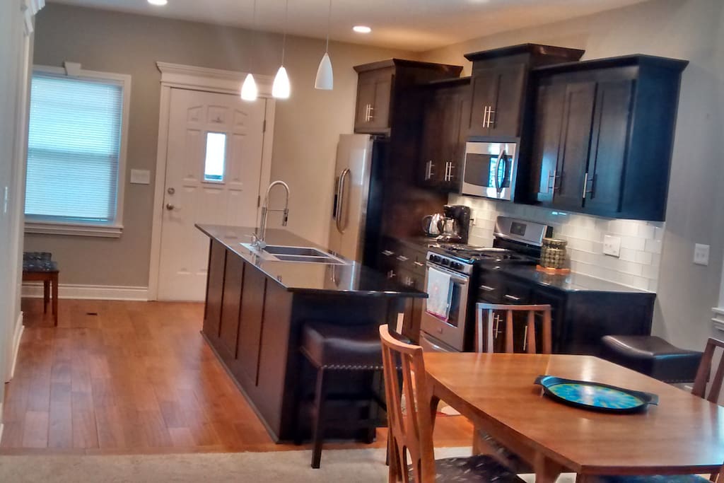 The spacious dining area and kitchen afford several working and eating spaces, including bar areas with power outlets for laptop docking.