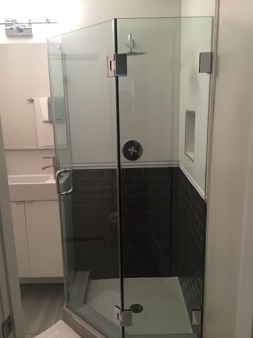 Private rain fall shower in full bathroom.