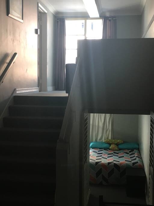 The apartment features two rooms with double size mattress, flowing over two levels. There are stairs to access to the rooms.