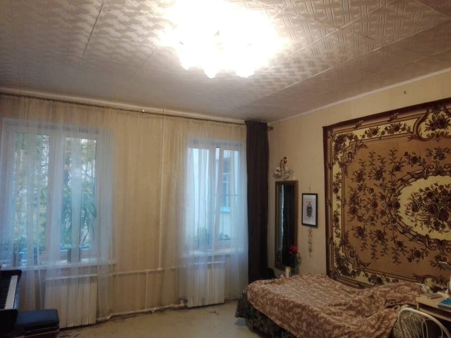 The apartment is bright and cozy; on the right is a bed for one person