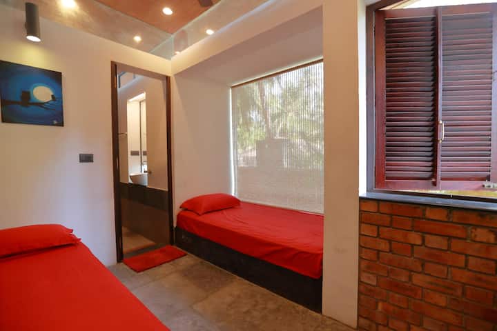 A cozy Non ac bedroom on the  ground floor, two single beds, with attached bathroom