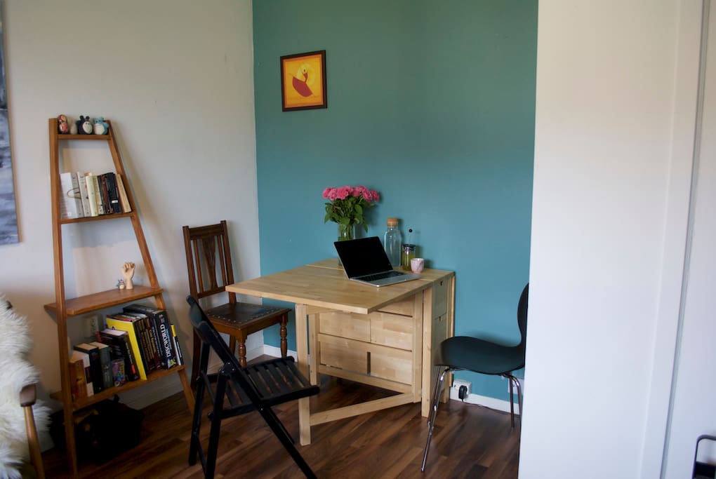 Dining part of living room, with folding table suited for dining or working.