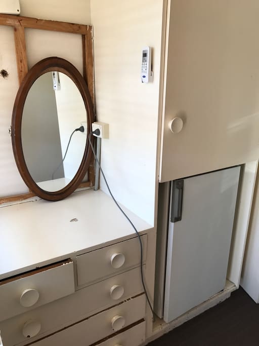 Cupboard and drawer space, a working and clean bar fridge, split system is on wall in the top of this pic