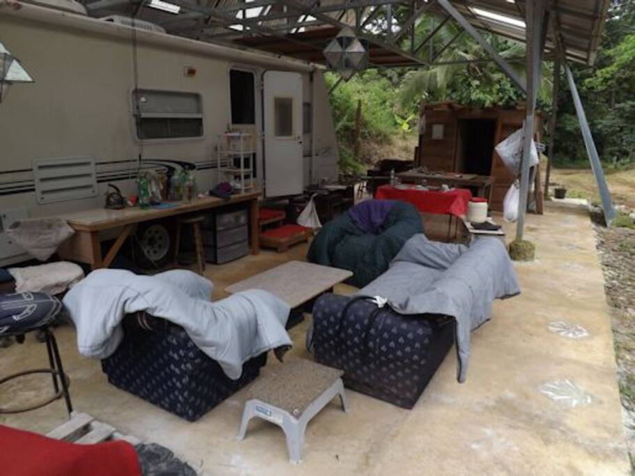 Covered patio with tables, chairs, kitchen