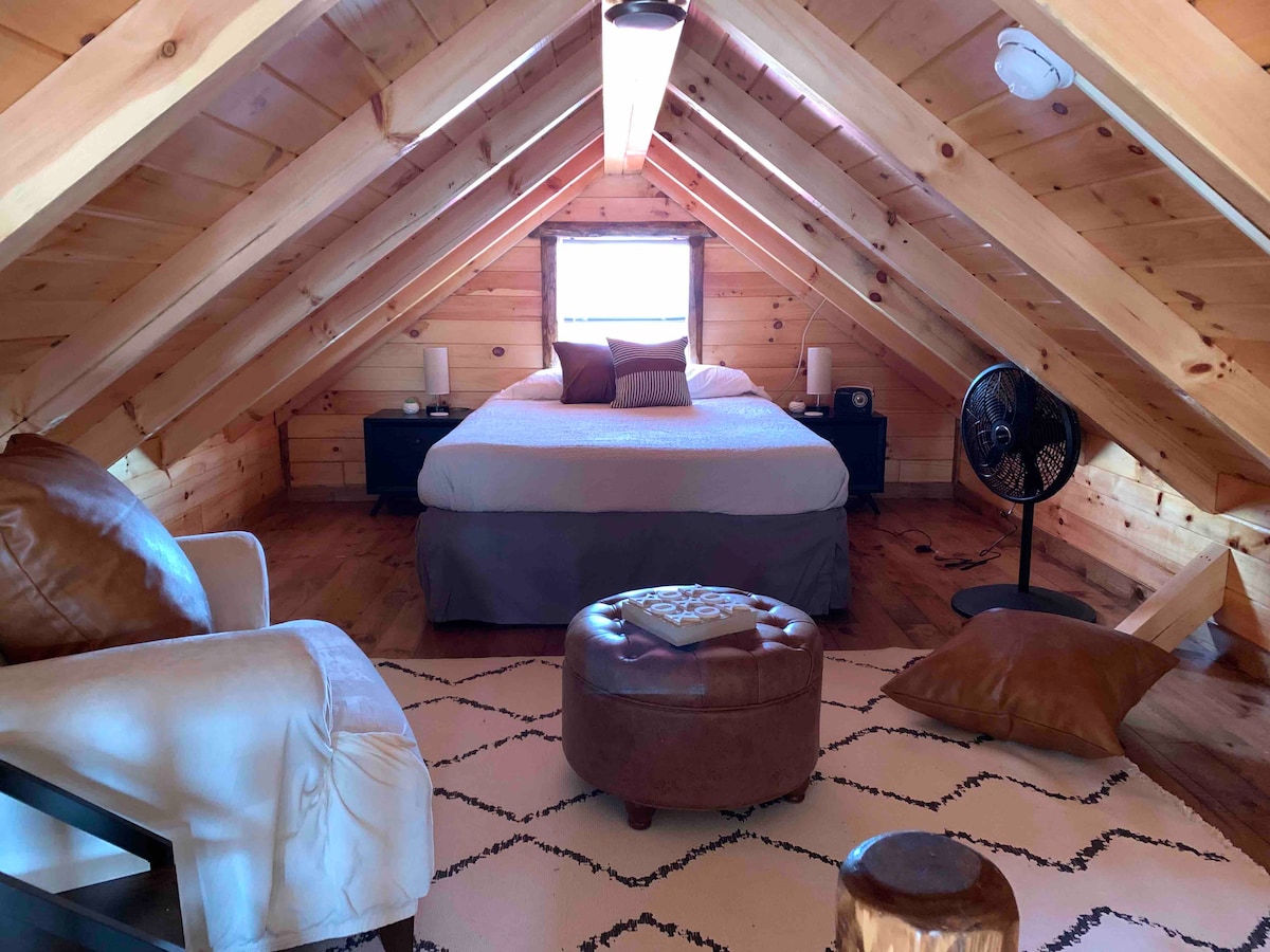 Upstairs bedroom, queen bed, comfy chair, ottoman, fan, two end tables, lamps with USB ports, be careful with the dormer ceilings, etc.