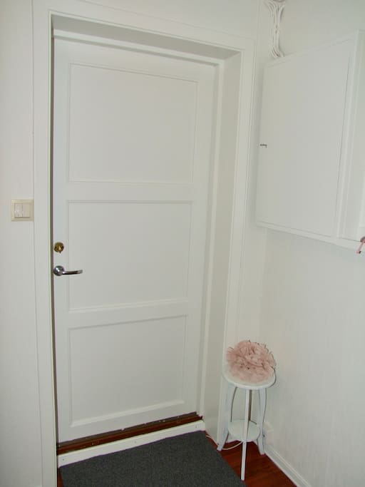 The door leading outside. Stairs up to the first floor/ground floor. We have changed the lock to a lock with a digital code.