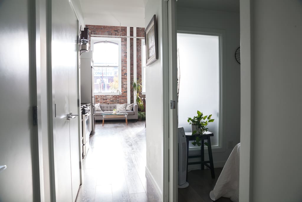 Front entrance hallway; ensuite bedroom on the right and three storage closets.