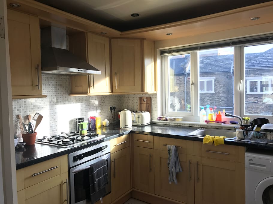 Sunny kitchen for coffee making, we have a moka pot and filter with fresh grinds at the ready.