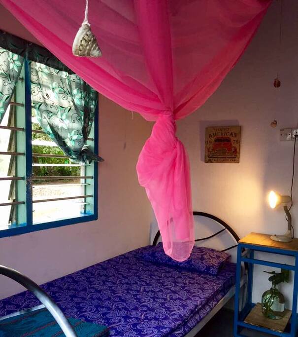 Single bed with mosquito net and reading light