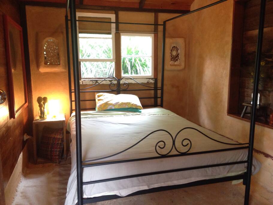 Cosy bedroom with rendered walls and candle alcoves