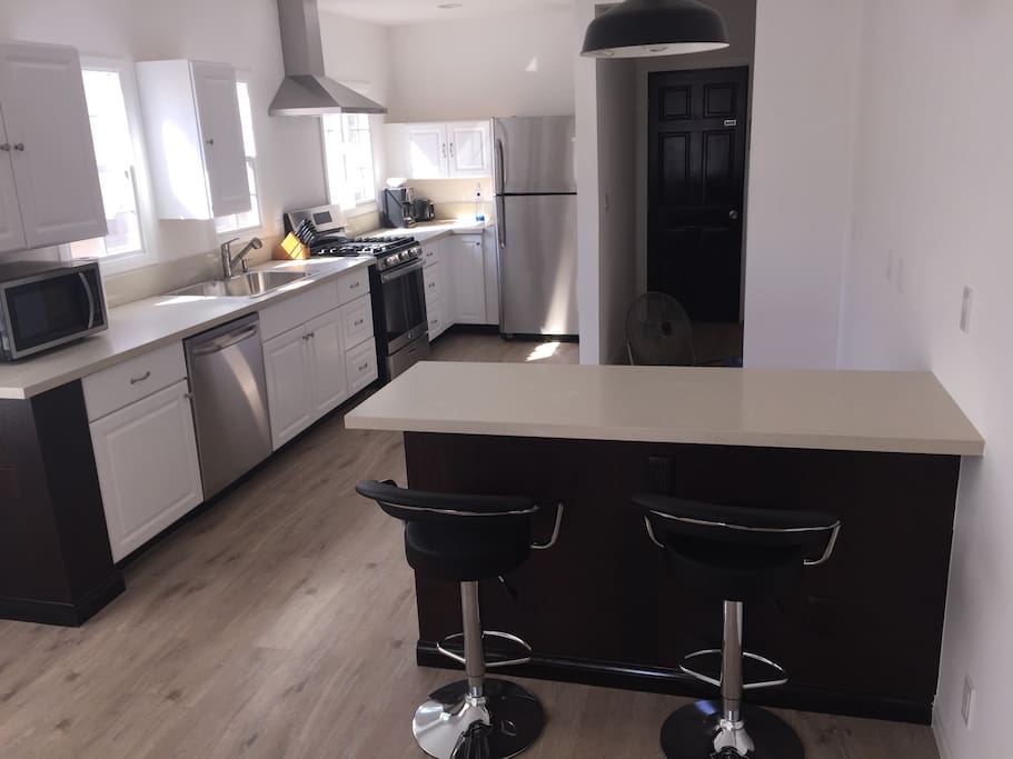 Large open kitchen and island with bar stools