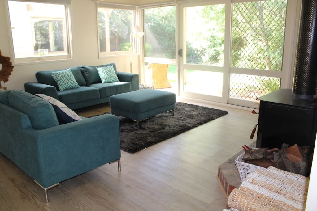 Front lounge room with split system and an open fire
