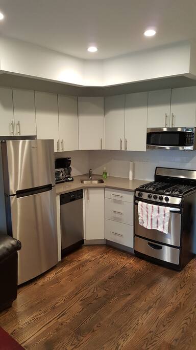 Brand new appliances including microwave, coffee maker, toaster and dishwasher.