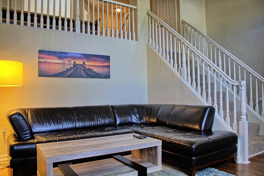 Living room with sectional couch and giant 60 inch tv