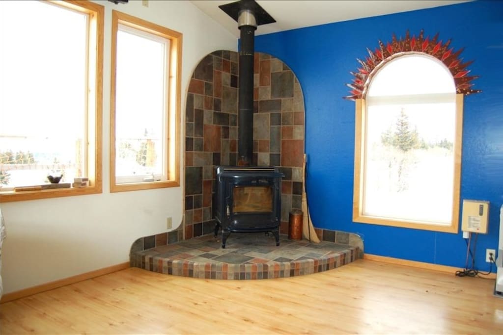 Wood stove and window overlooking the garden