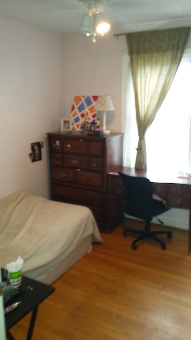 Bedroom with bed, desk, drawers, and closet (to the right, not in pic)