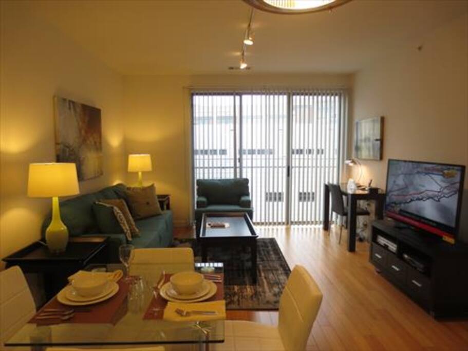 Spacious living room with over-sized windows providing lovely natural light