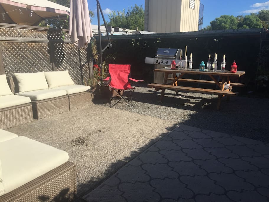 Sunny patio with sectional and BBQ