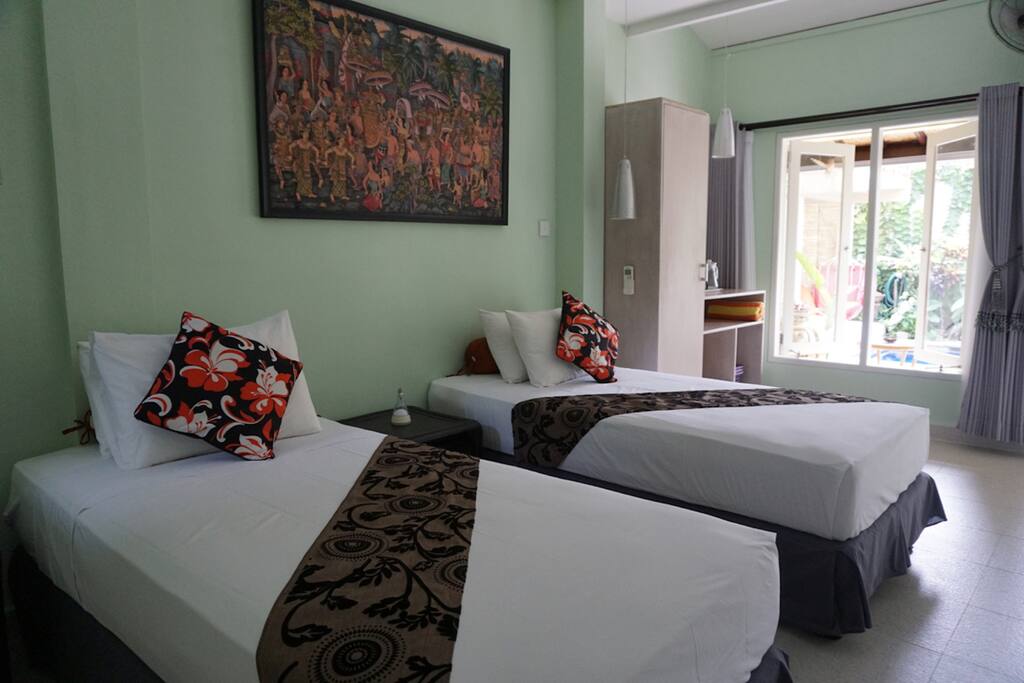 2 king single beds (120 x 200) with digital security box, enclosed ensuite bathroom and TV & DVD player.
The air-conditioned and fan cooled bedroom features custom designed handcrafted furniture, fine Balinese linens and soft furnishings, reading lights and tea and coffee making facilities plus unlimited filtered drinking water.