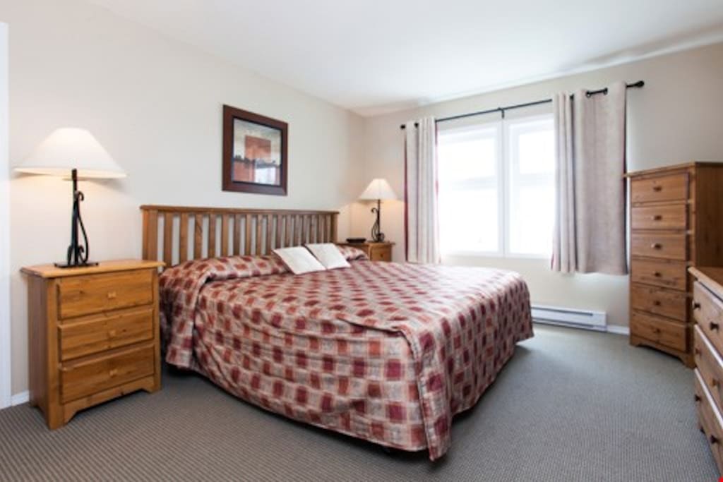 The second bedroom features a comfortable queen bed and ample cupboard space to store your belongings.