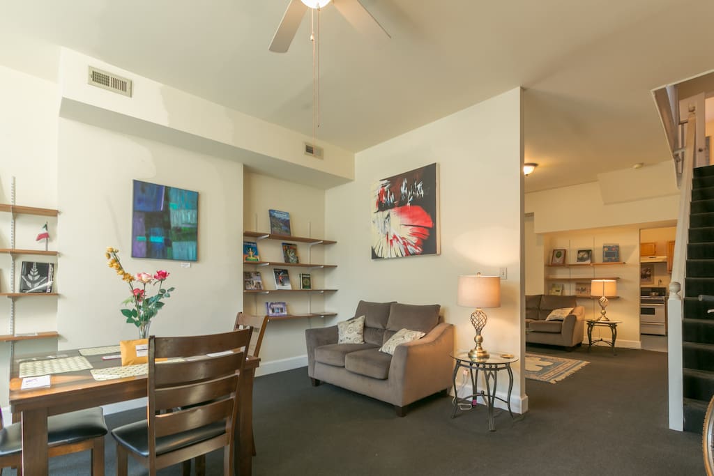 Dining room living room combination filled with artworks and s