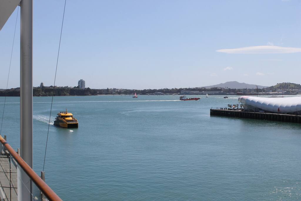 View to The Cloud entertainment centre with Rangitoto volcanic island in the background. Ferry arriving!