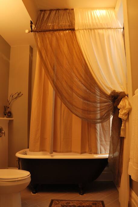 The vintage clawfoot tub is the focal point of the private bath (photo by Michael Moessner)