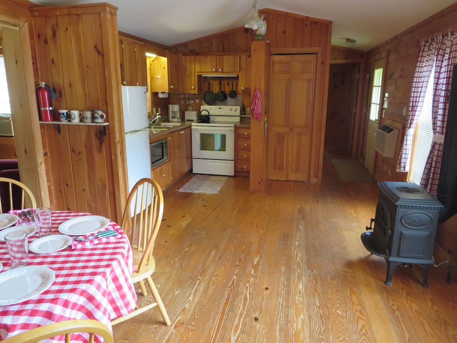 Kitchen and dining area with gas fired Franklin stove.