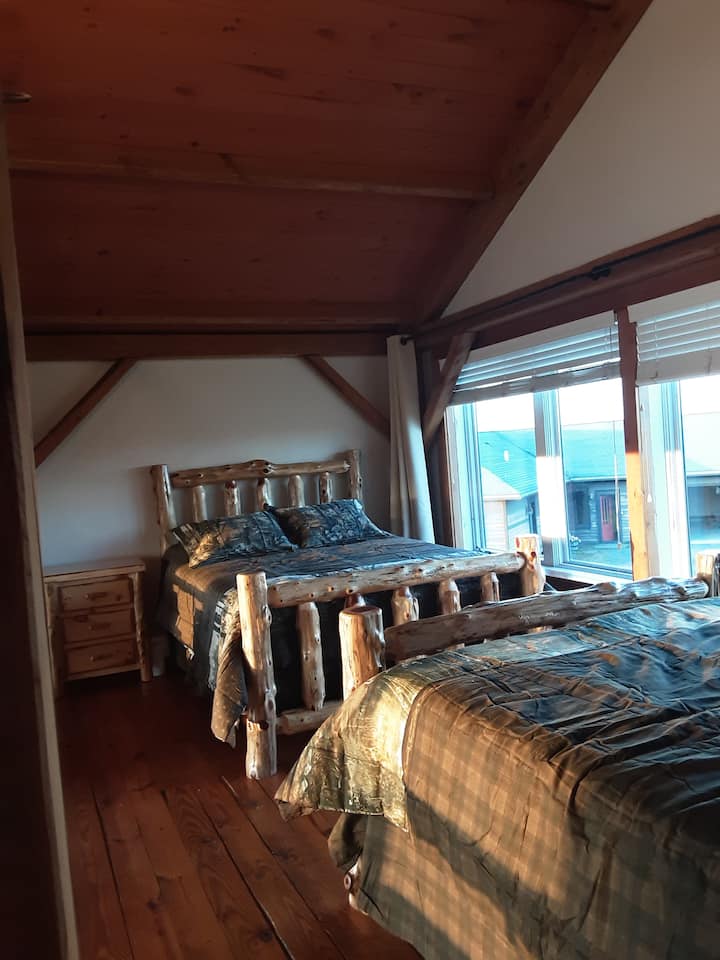 2nd floor bedroom with two queen log frame beds