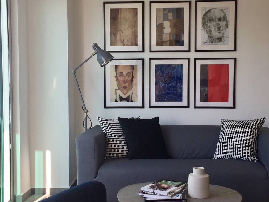 cozy sofa with wall art gallery to spend the afternoon reading a book.