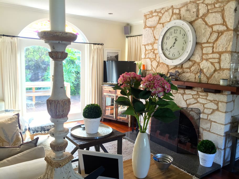 Living room double French doors open onto the decked courtyard