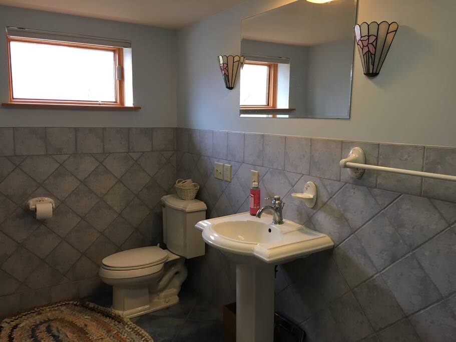 Ground floor bathroom has beautiful tile work and a deep bathtub