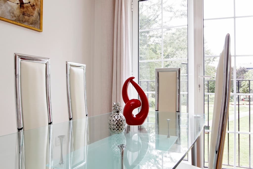 Glass dining table with the leather chairs